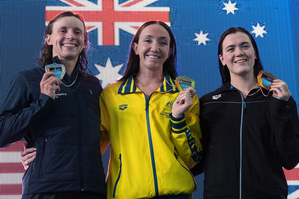 From left, silver medalist Katie Ledecky, of the United States, gold medalist Lani Pallister, of Australia, and bronze medalist Erika Fairweather, of New Zealand celebrate after the the women's 400 meters freestyle final at the Pan Pacific Swimming Championships Friday, Aug. 14, 2026 in Irvine, Calif. (AP Photo/Gregory Bull)