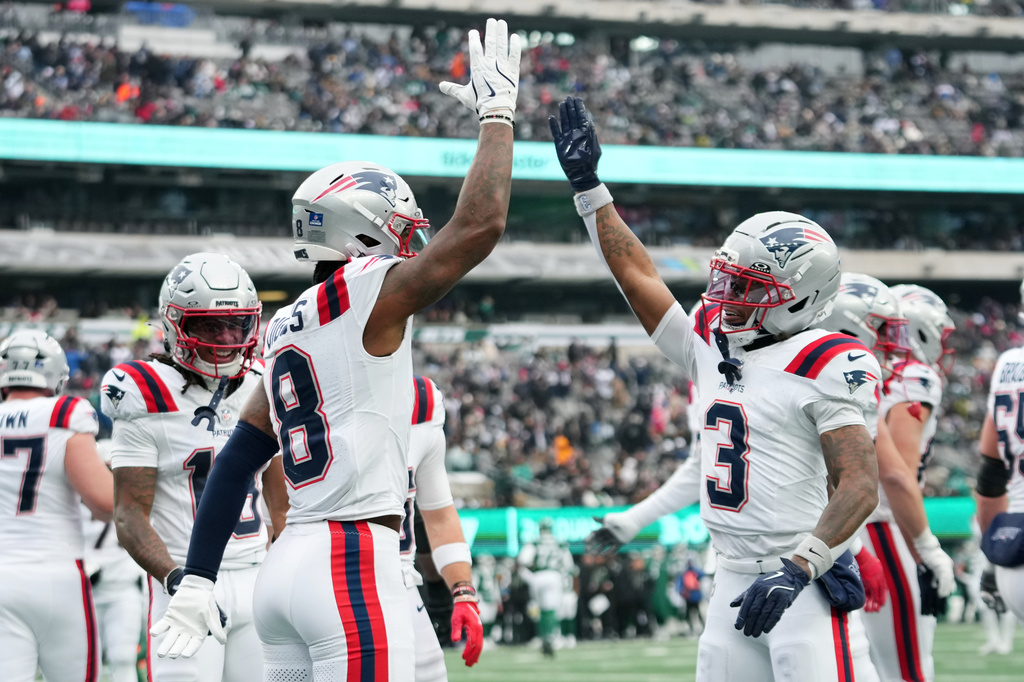 New England Patriots wide receiver Stefon Diggs (8) celebrates after a touchdown against the New York Jets with teammate Demario Douglas (3) during the first half of an NFL football game, Sunday, Dec. 28, 2025, in East Rutherford, N.J. (AP Photo/Frank Franklin)