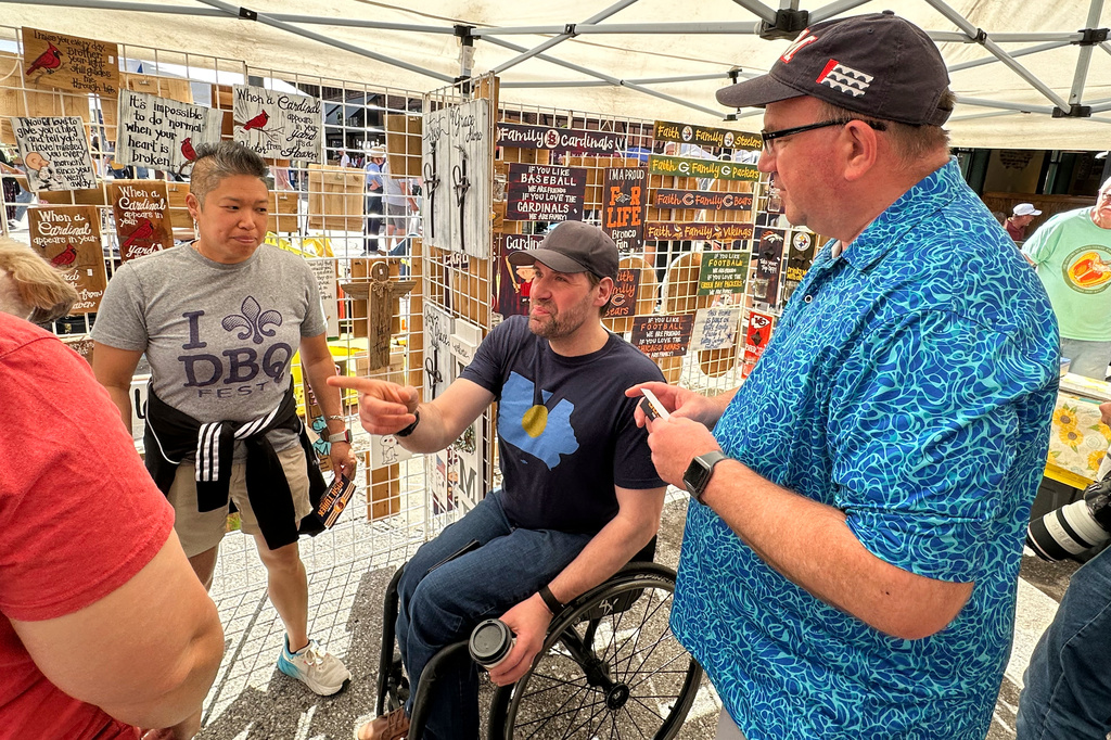 Iowa state Rep. Josh Turek, a Democratic candidate for U.S. Senate, talks with voters in Des Moines, Iowa, Saturday, May 23, 2026. (AP Photo/Hannah Fingerhut)