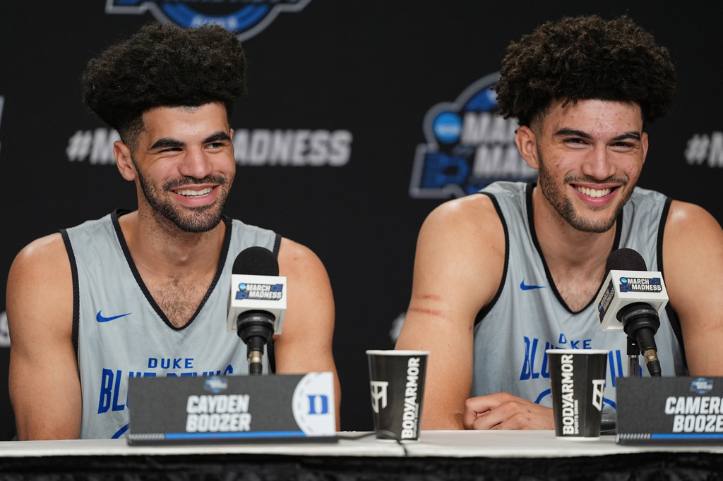 Duke guard Cayden Boozer, left, and Duke forward Cameron Boozer, right, share a laugh during a press conference ahead of a game against UConn in the Elite Eight of the NCAA college basketball tournament Saturday, March 28, 2026, in Washington. (AP Photo/Abbie Parr)