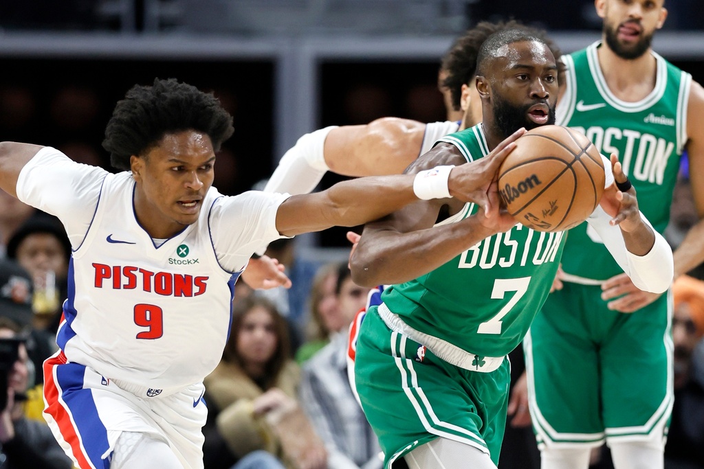 Detroit Pistons guard Ausar Thompson (9) knocks the ball away from Boston Celtics guard Jaylen Brown (7) during the first half of an NBA basketball game Monday, Jan. 19, 2026, in Detroit. (AP Photo/Duane Burleson)