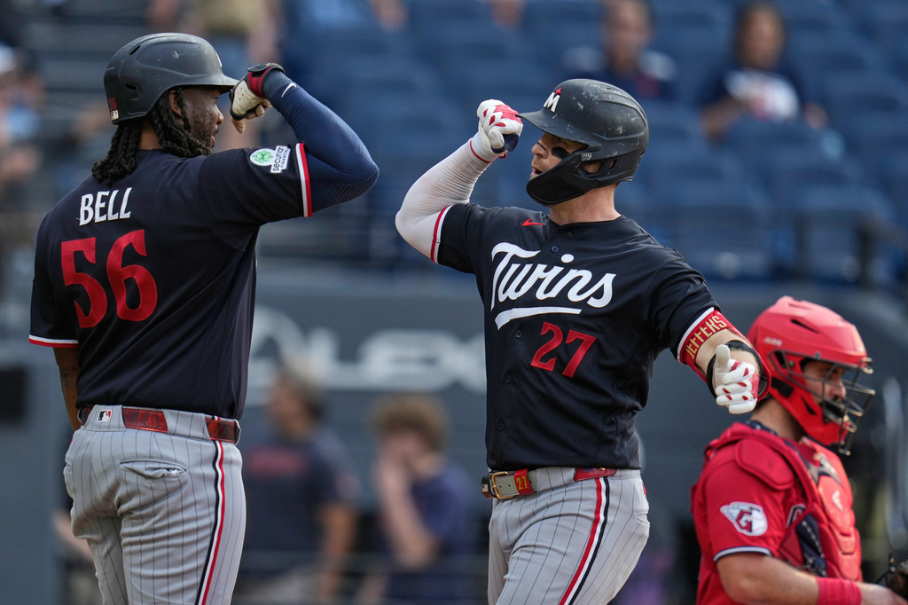 Minnesota Twins' Ryan Jeffers (27) celebrates his home run with Josh Bell (56) in the first inning of a baseball game against the Cleveland Guardians in Cleveland, Tuesday, July 21, 2026. (AP Photo/Sue Ogrocki)