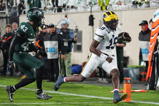 Michigan quarterback Bryce Underwood, right, runs past Michigan State safety Malik Spencer to score a touchdown during the first half of an NCAA college football game Saturday, Oct. 25, 2025, in East Lansing, Mich. (AP Photo/Ryan Sun) Michigan quarterback Bryce Underwood, right, runs past Michigan State safety Malik Spencer to score a touchdown during the first half of an NCAA college football game Saturday, Oct. 25, 2025, in East Lansing, Mich. (AP Photo/Ryan Sun)