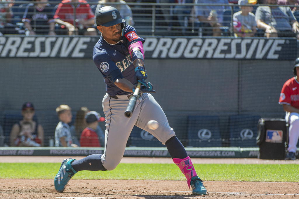 Seattle Mariners' Julio Rodriguez hits an RBI single off Cleveland Guardians relief pitcher Matt Festa during the seventh inning of a baseball game, Sunday, Aug. 31, 2025, in Cleveland. (AP Photo/Phil Long)