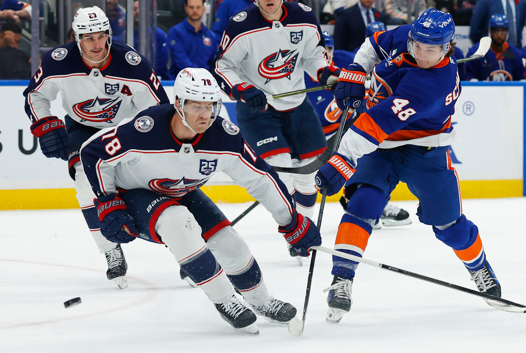 New York Islanders defenseman Matthew Schaefer (48) shoots the puck against Columbus Blue Jackets defenseman Damon Severson (78) during the second period of an NHL hockey game, Sunday, Nov. 2, 2025, in New York. (AP Photo/Noah K. Murray)