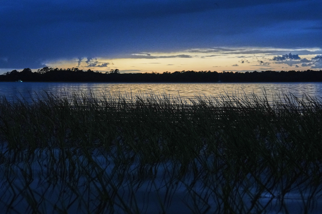 FILE - The sun sets over a salt marsh Monday, Oct. 6, 2025, in Charleston, S.C. (AP Photo/Joshua A. Bickel, File)