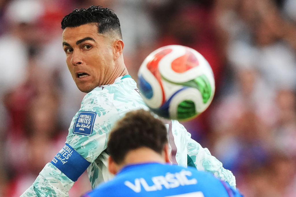 Portugal's Cristiano Ronaldo (7) watches as Croatia's Nikola Vlasic (13) heads the ball during the World Cup round of 32 soccer match between Portugal and Croatia in Toronto, Thursday, July 2, 2026. (Nathan Denette/The Canadian Press via AP)