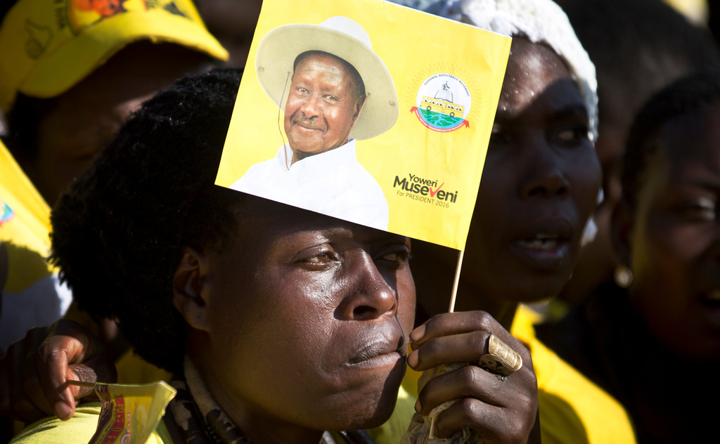 FILE - A supporter holds a flag of Uganda's long-time President Yoweri Museveni at an election rally at Kololo Airstrip in Kampala, Uganda Tuesday, Feb. 16, 2016. (AP Photo/Ben Curtis, File)