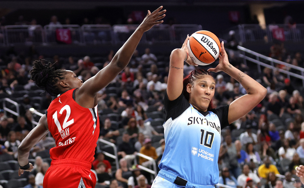 Chicago Sky center Kamilla Cardoso (10) passes in front of Las Vegas Aces guard Chelsea Gray (12) during the first half of a WNBA basketball game Sunday, Sept. 7, 2025, in Las Vegas. (Steve Marcus/Las Vegas Sun via AP)