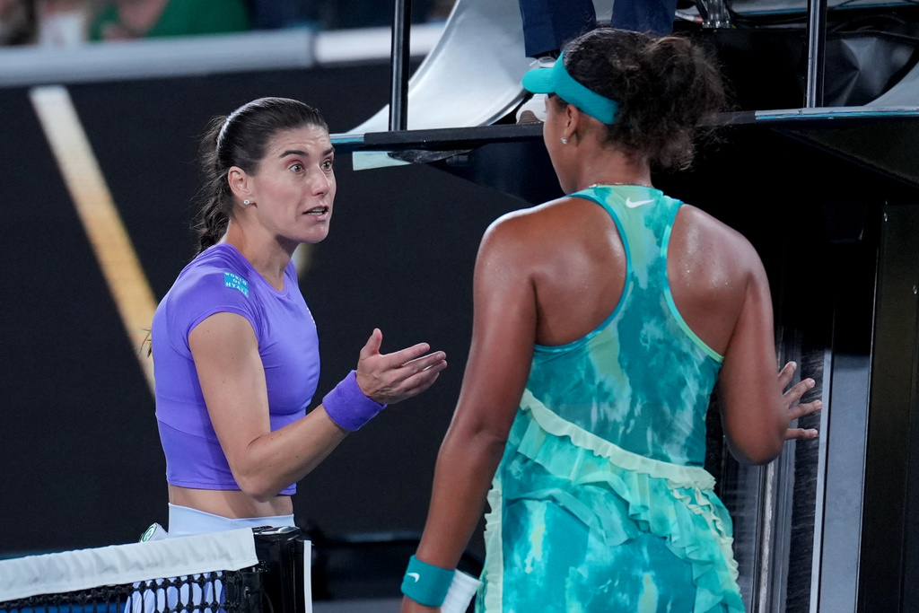 Naomi Osaka, right, of Japan talks with Sorana Cirstea, left, of Romania following their second round match at the Australian Open tennis championship in Melbourne, Australia, Thursday, Jan. 22, 2026. (AP Photo/Dita Alangkara)