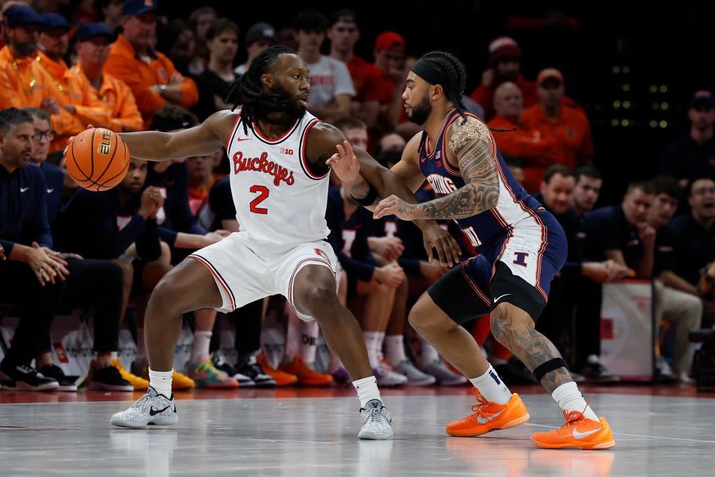Ohio State's Bruce Thornton, left, looks for an open pass against Illinois' Kylan Boswell during the first half of an NCAA college basketball game, Tuesday, Dec. 9, 2025, in Columbus, Ohio. (AP Photo/Jay LaPrete)