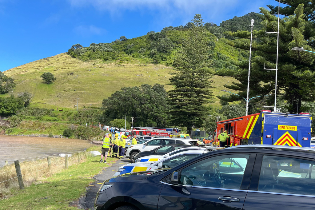 Emergency workers survey the scene after a landslide hit a campground at Mt. Maunganui, New Zealand, Thursday, Jan. 22, 2026. (Stuff via AP)