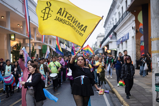 Activist Yren Rotela waves an Amnesty International flag during a Pride March in Asuncion, Paraguay, Saturday, June 28, 2025. (AP Photo/Jorge Saenz) Activist Yren Rotela waves an Amnesty International flag during a Pride March in Asuncion, Paraguay, Saturday, June 28, 2025. (AP Photo/Jorge Saenz)