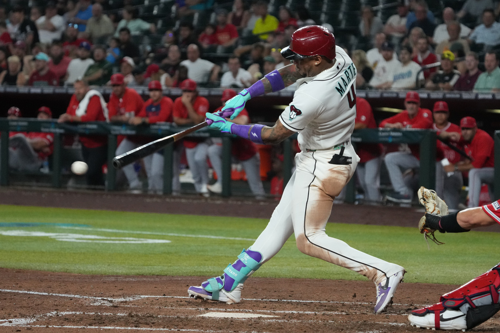 Arizona Diamondbacks' Ketel Marte hits a two-run double against the Los Angeles Angels in the fifth inning of a baseball game, Wednesday, June 17, 2026, in Phoenix. (AP Photo/Rick Scuteri)