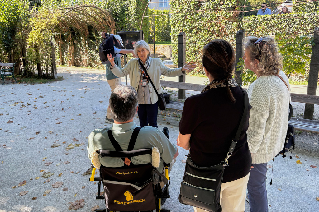 In this photo taken with a smartphone, Elisabeth von Trapp, center, guides visitors to locations of the musical film "The Sound of Music" in Salzburg, Austria, Sunday, Sept. 20, 2026. (AP Photo/Philipp-Moritz Jenne)