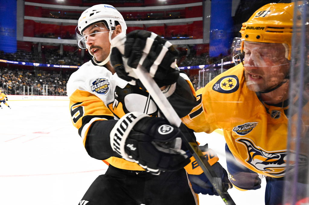 Pittsburgh Penguins' Erik Karlsson, left, and Nashville Predators' Steven Stamkos battle in the corner during a NHL Global Series hockey game, Friday, Nov. 14, 2025, in Stockholm, Sweden. (Henrik Montgomery/TT News Agency via AP)