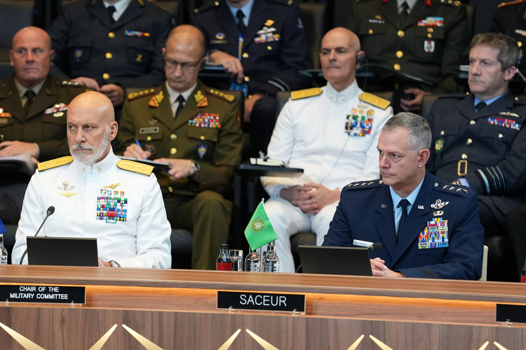 NATO's Supreme Allied Commander Europe General Alexus Grynkewich, front right, and Chair of the NATO Military Committee Admiral Giuseppe Cavo Dragone, front left, listen to a speech by United States Defense Secretary Pete Hegseth during a meeting of the North Atlantic Council in defense ministers format at NATO headquarters in Brussels, Thursday, June 18, 2026. (AP Photo/Virginia Mayo)