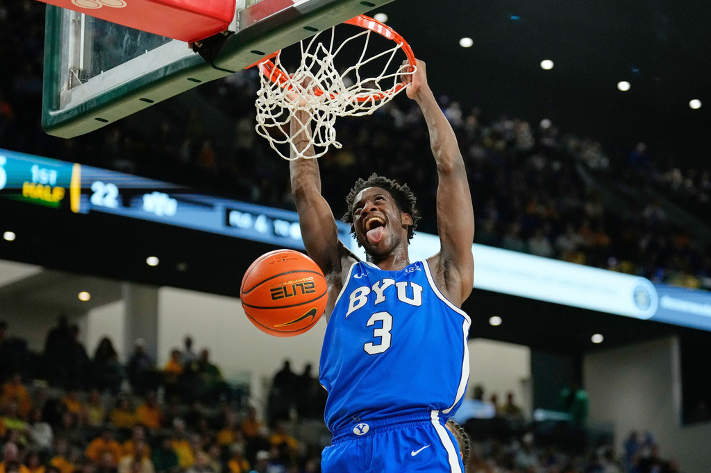 FILE - BYU forward AJ Dybantsa dunks in the first half of an NCAA college basketball game against Baylor Tuesday, Feb. 10, 2026, in Waco, Texas. (AP Photo/Tony Gutierrez, File