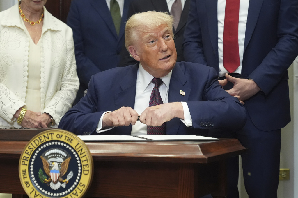President Donald Trump signs an executive order restarting the Presidential Fitness Test in public schools, Thursday, July 31, 2025, in the Roosevelt Room of the White House in Washington. (AP Photo/Jacquelyn Martin)