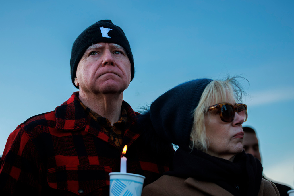 Minnesota Gov. Tim Walz and his wife, Gwen Walz, attend a vigil honoring Renee Good on Friday, Jan. 9, 2026, in St. Paul, Minn., outside the Minnesota State Capitol. (Kerem Yücel/Minnesota Public Radio via AP)