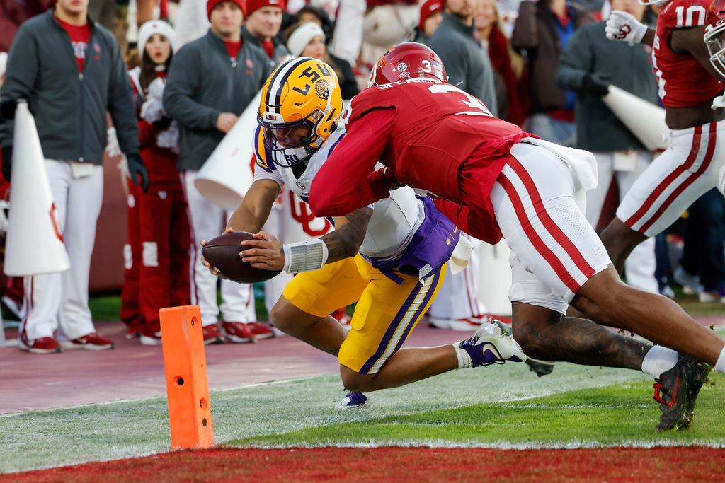 LSU quarterback Michael van Buren Jr. (11) is pushed out of bounds at the goal line by Oklahoma defensive back Robert Spears-Jennings (3) during the third quarter of an NCAA college football game Saturday, Nov. 29, 2025, in Norman, Okla. (AP Photo/Alonzo Adams)