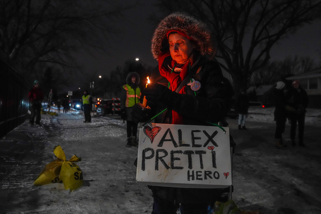 A woman attends a vigil for Alex Pretti who was fatally shot by a federal agent, at the Minneapolis VA Hospital, where Pretti worked, on Sunday, Feb. 1, 2026, in Minneapolis. (AP Photo/Ryan Murphy)