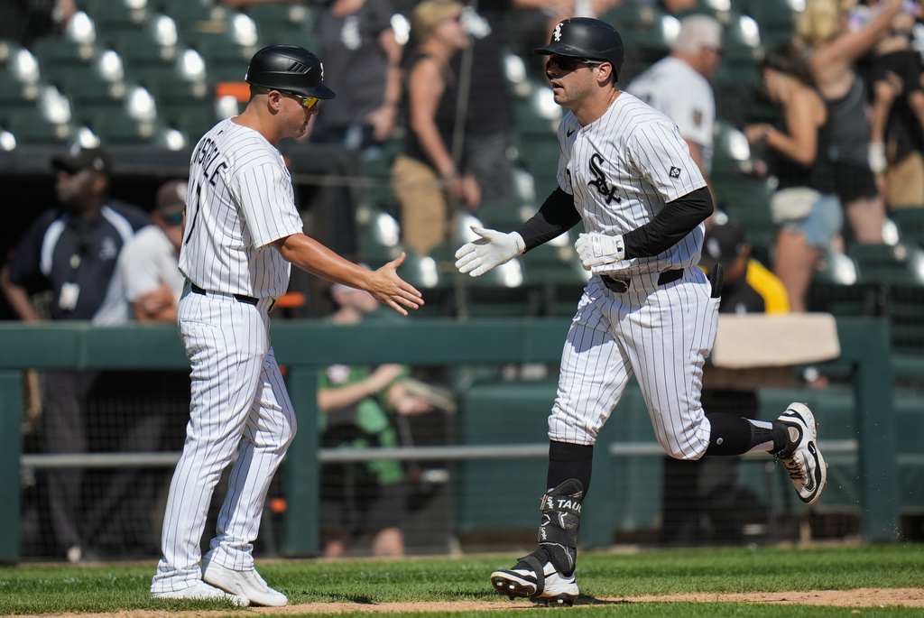 Chicago White Sox designated hitter Mike Tauchman, right, slaps hands with third base coach Justin Jirschele (17) after hitting a home run during the fourth inning of a baseball game against the Baltimore Orioles, Wednesday, Sept. 17, 2025, in Chicago. (AP Photo/Erin Hooley)