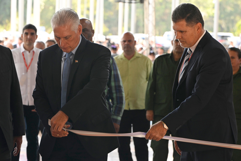 FILE - Cuban President Miguel Diaz-Canel, left, cuts the ribbon alongside Oscar Pérez-Oliva Fraga, the great nephew of former President Raul Castro, as they inaugurate a fair for prospective buyers from abroad in Havana, Nov. 24, 2025. (Norlys Perez/Pool Photo via AP, File)