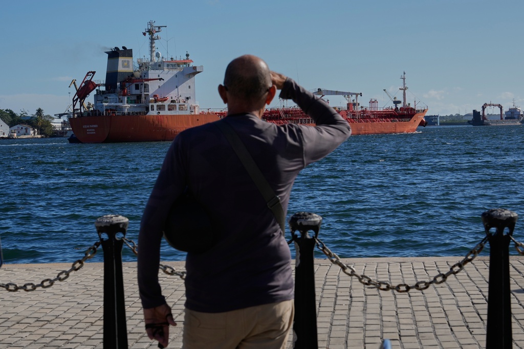 A person watches the oil tanker Ocean Mariner, Monrovia, arrive to the bay in Havana, Cuba, Friday, Jan. 9, 2026. (AP Photo/Ramon Espinosa)