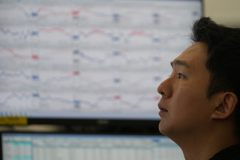A dealer watches computer monitors at a dealing room of Hana Bank in Seoul, South Korea, Thursday, Dec. 18, 2025. (AP Photo/Lee Jin-man)