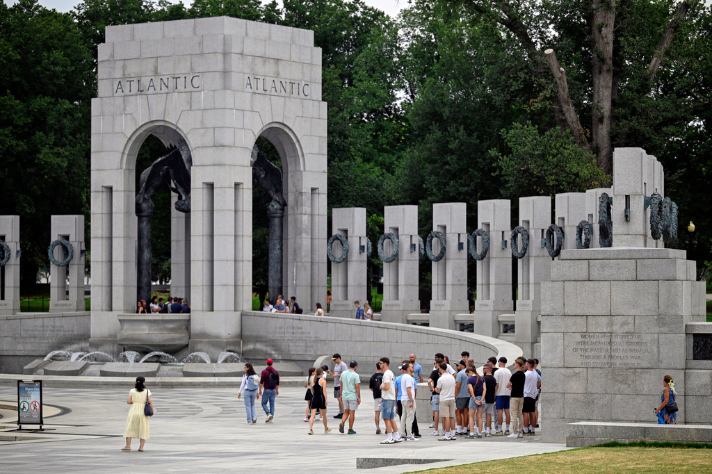 Visitors walk the WWII memorial the morning after it was vandalized, shown Friday, Aug. 14, 2026, in Washington. (AP Photo/John McDonnell)
