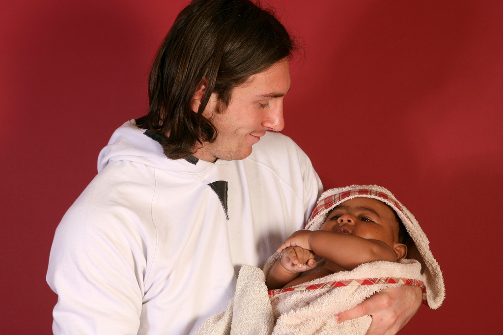 20-year-old soccer star Lionel Messi cradles Lamine Yamal, who was merely six months old at the time during a photo session in Sept. 2007 in the dressing room of the Camp Nou stadium in Barcelona, Spain. (AP Photo/Joan Monfort)