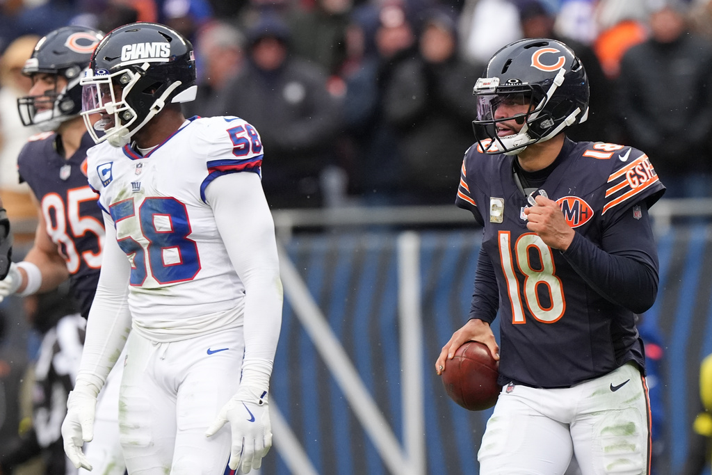 Chicago Bears quarterback Caleb Williams (18) celebrates after scoring a touchdown during the second half of an NFL football game against the New York Giants, Sunday, Nov. 9, 2025, in Chicago. (AP Photo/Nam Y. Huh)