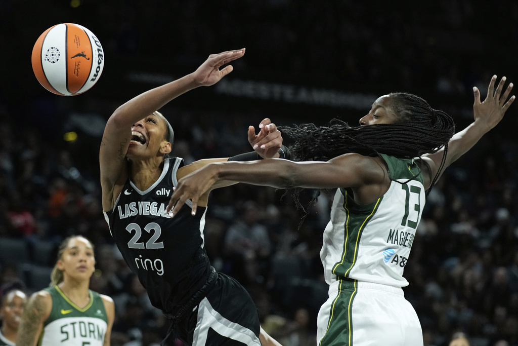 Las Vegas Aces center A'ja Wilson (22) and Seattle Storm forward Ezi Magbegor (13) battle for the ball during the second half of Game 3 in the first round of the WNBA basketball playoffs Thursday, Sept. 18, 2025, in Las Vegas. (AP Photo/John Locher)
