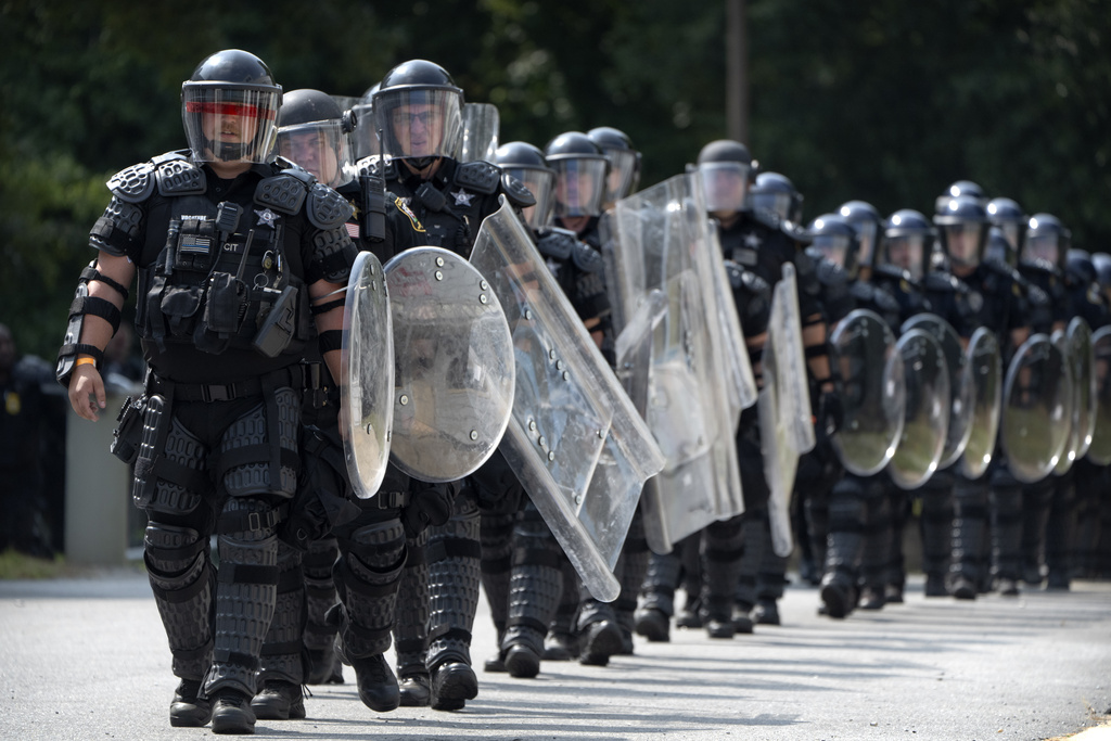 During a training exercise involving local and federal law enforcement organized by the U.S. Capitol Police, police officers wearing protective equipment march at the U.S. Secret Service James J. Rowley Training Center Friday, Sept. 5, 2025, in Laurel, Md. (AP Photo/Mark Schiefelbein)