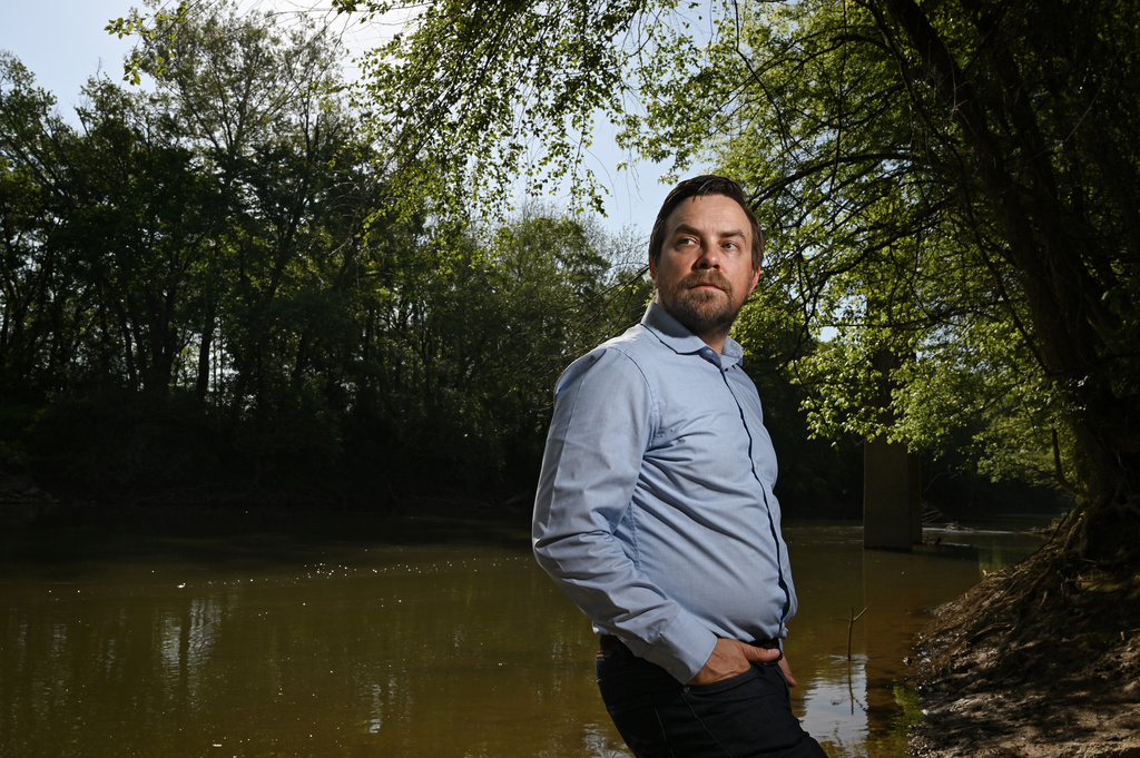 Jesse Demonbreun-Chapman, executive director and riverkeeper for the Coosa River Basin Initiative, poses for a portrait on the banks of the Coosawattee River at the New Echota launch in Calhoun, Ga., on April 3, 2026. (Hyosub Shin/Atlanta Journal-Constitution via AP)