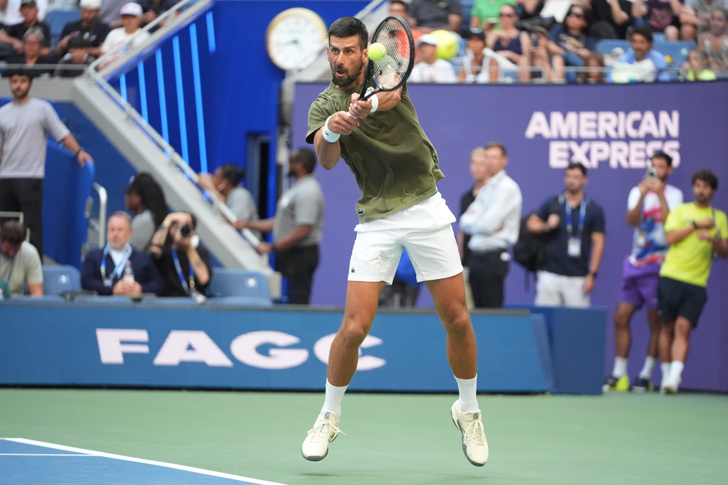 Novak Djokovic, of Serbia, returns the ball to Alexander Zverev, of Germany, during a practice at the U.S. Open tennis championships Wednesday, Aug. 26, 2026, in New York. (AP Photo/Frank Franklin II)
