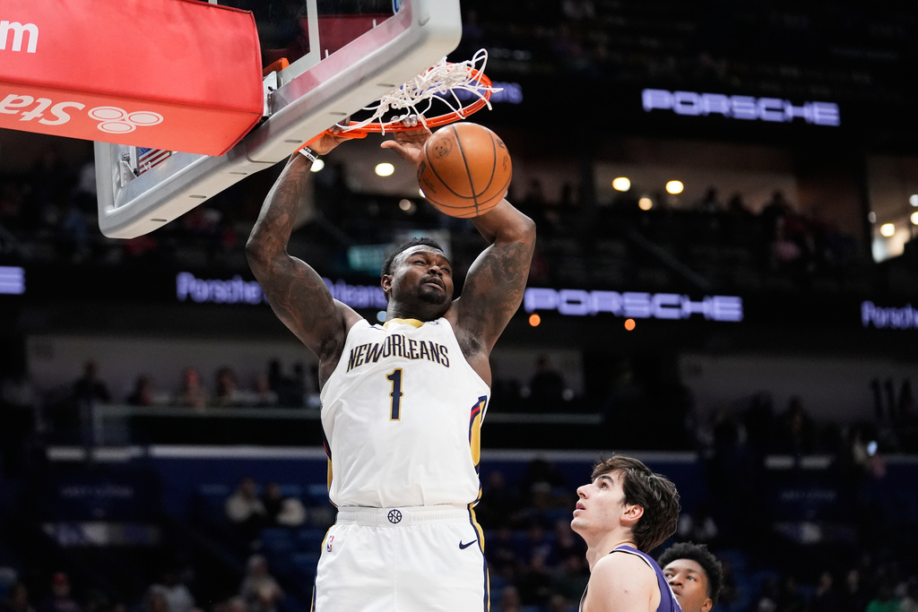 New Orleans Pelicans forward Zion Williamson (1) slam dunks over Sacramento Kings center Maxime Raynaud in the first half of an NBA basketball game, Monday, Feb. 9, 2026, in New Orleans. (AP Photo/Gerald Herbert)
