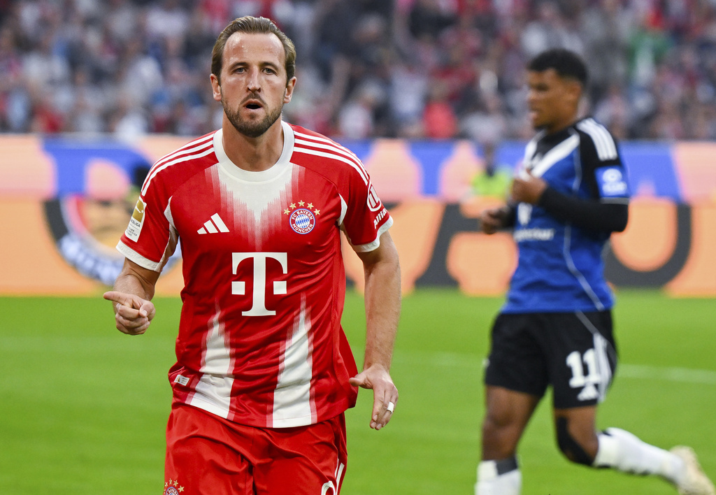 Munich's Harry Kane celebrates after scoring his side's third goal during the German Bundesliga soccer match between FC Bayern Munich and Hamburger SV in Munich, Germany, Saturday, Sept. 13, 2025. (Sven Hoppe/dpa via AP)
