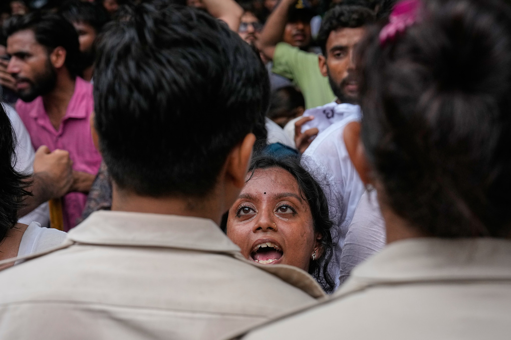A supporter of the Cockroach Janta Party confront police officers as protesters attempt to march toward India's Parliament, demanding the resignation of the education minister, in New Delhi, India, Monday, July 20, 2026. (AP Photo/Manish Swarup)