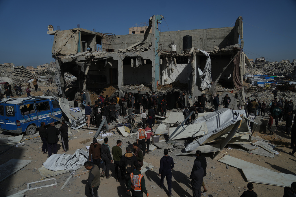 Palestinians search for bodies and survivors from the rubble of police station after it was targeted by an Israeli army strike in Gaza City Saturday, Jan. 31, 2026. (AP Photo/Jehad Alshrafi)