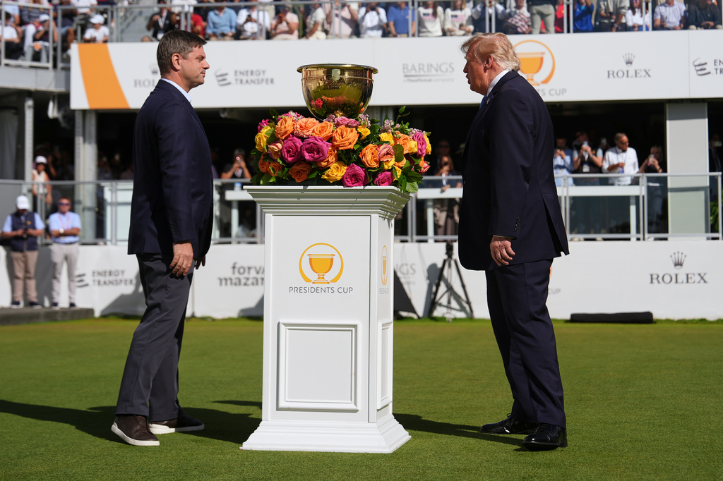 President Donald Trump, right, speaks with PGA Tour CEO Brian Rolapp at the Presidents Cup golf tournament at Medinah Country Club, Sunday, Sept. 27, 2026, in Medinah, Ill. (AP Photo/Julia Demaree Nikhinson)