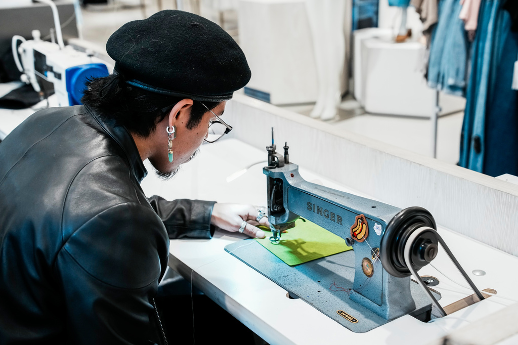 Tailor Marco Lema, 35, of Ecuador, works on a embroidery machine at Nordstrom Manhattan flagship in New York, Monday, March 23, 2026. (AP Photo/Eduardo Munoz Alvarez) CORRECTION: Corrects to Nordstrom Manhattan flagship, not Nordstrom headquarters