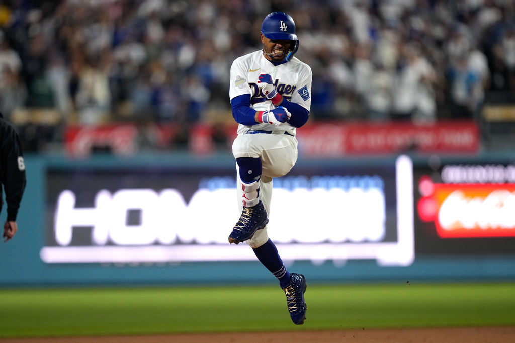 Los Angeles Dodgers' Mookie Betts celebrates after hitting a three-run home run during the third inning of a baseball game against the Arizona Diamondbacks, Friday, March 27, 2026, in Los Angeles. (AP Photo/Mark J. Terrill)