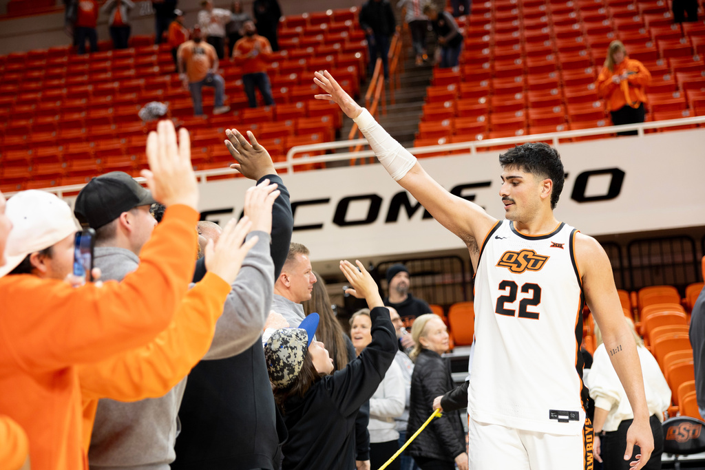 Oklahoma State center Parsa Fallah (22) celebrates with fans after the NCAA college basketball game Central Florida, Tuesday, Jan. 6, 2026 in Stillwater, Okla. (AP Photo/Mitch Alcala)