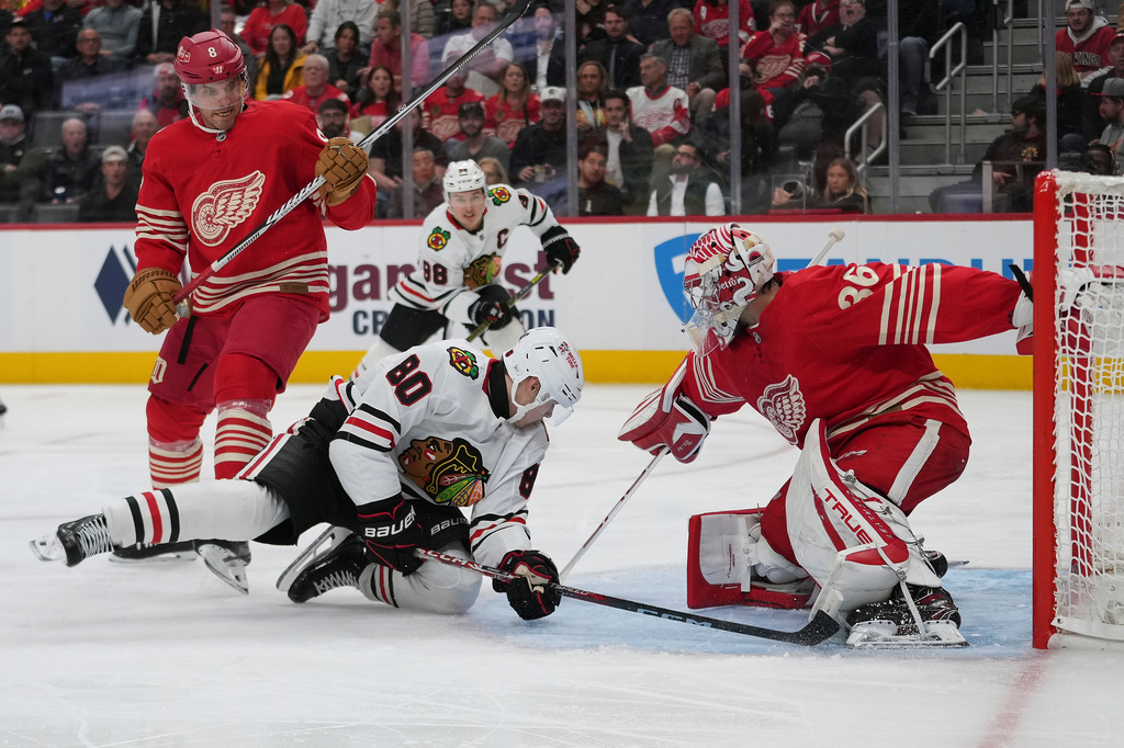 Detroit Red Wings goaltender John Gibson (36) stops a Chicago Blackhawks right wing Roman Kantserov (80) shot in the second period of an NHL hockey game Thursday, Oct. 29, 2026, in Detroit. (AP Photo/Paul Sancya)