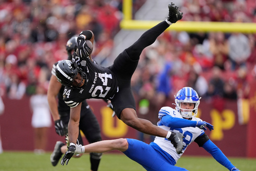 Iowa State running back Abu Sama (24) leaps over BYU safety Tanner Wall for the first down during the first half of an NCAA college football game, Saturday, Oct. 25, 2025, in Ames, Iowa. (AP Photo/Matthew Putney) Iowa State running back Abu Sama (24) leaps over BYU safety Tanner Wall for the first down during the first half of an NCAA college football game, Saturday, Oct. 25, 2025, in Ames, Iowa. (AP Photo/Matthew Putney)