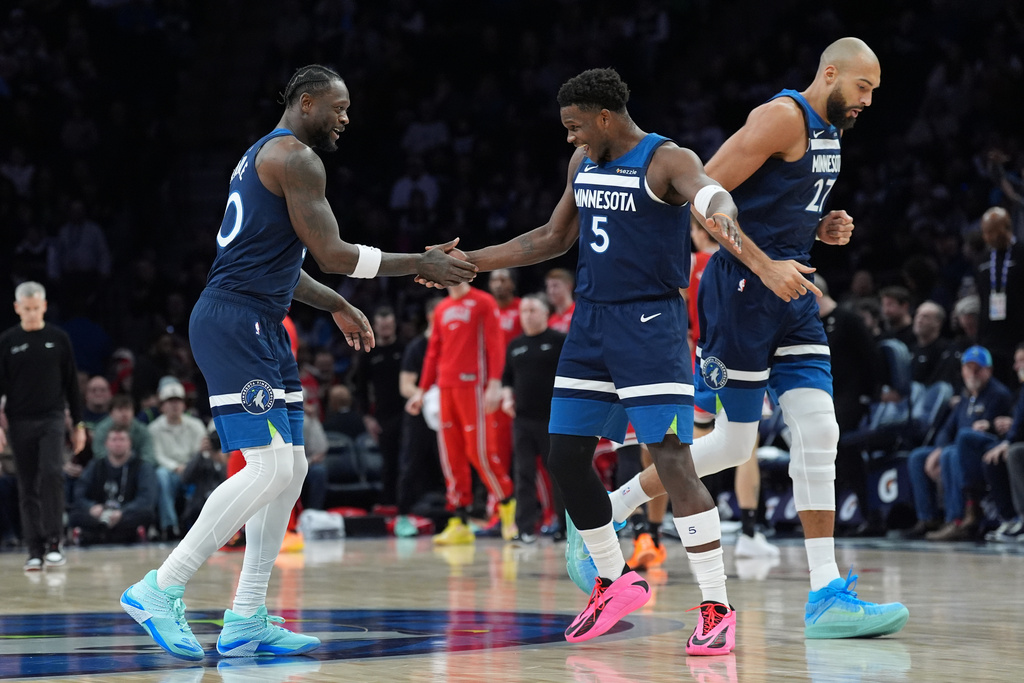 Minnesota Timberwolves forward Julius Randle, left, celebrates with guard Anthony Edwards (5) after making a 3-point basket during the first half of an NBA basketball game against the Chicago Bulls, Thursday, Jan. 22, 2026, in Minneapolis. (AP Photo/Abbie Parr)