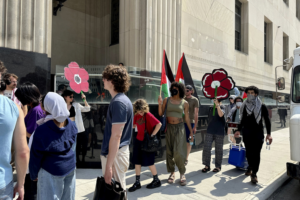 People carry Palestinian flags outside the federal courthouse in Detroit on Wednesday, June 10, 2026, after activists appeared in court on conspiracy charges. (AP Photo/Ed White)