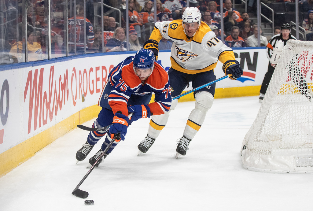 Nashville Predators' Michael McCarron (47) and Edmonton Oilers' Alec Regula (75) battle for the puck during second period NHL action, in Edmonton, Alberta, on Tuesday, Jan. 6, 2026. THE CANADIAN PRESS/Jason Franson/The Canadian Press via AP)